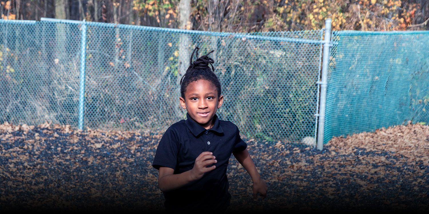 A student running on the playground.